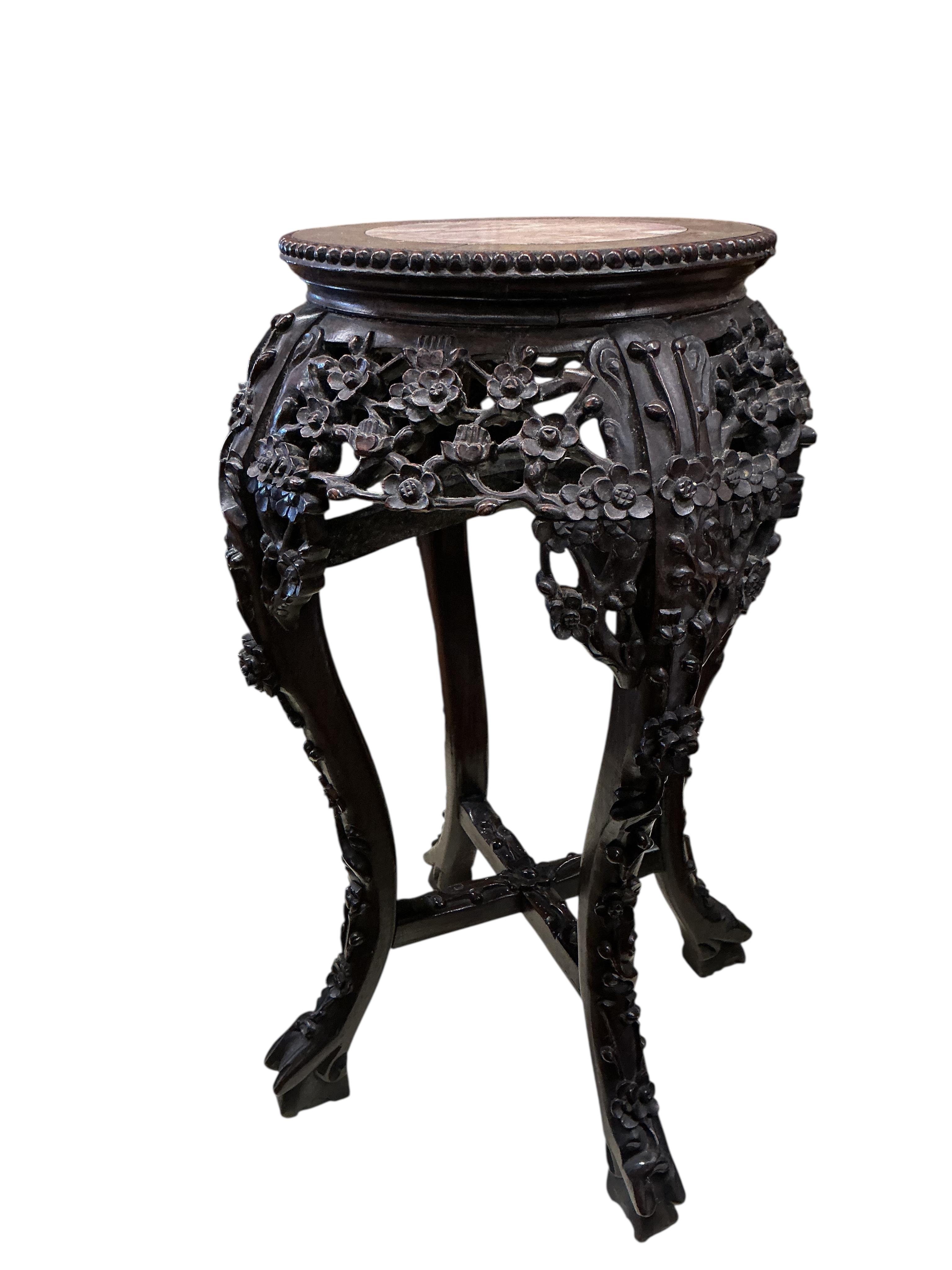 A Chinese carved padouk rouge marble topped jardiniere stand, height 60cm